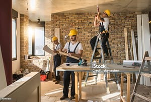 Busy construction workers working on home improvement in the apartment.